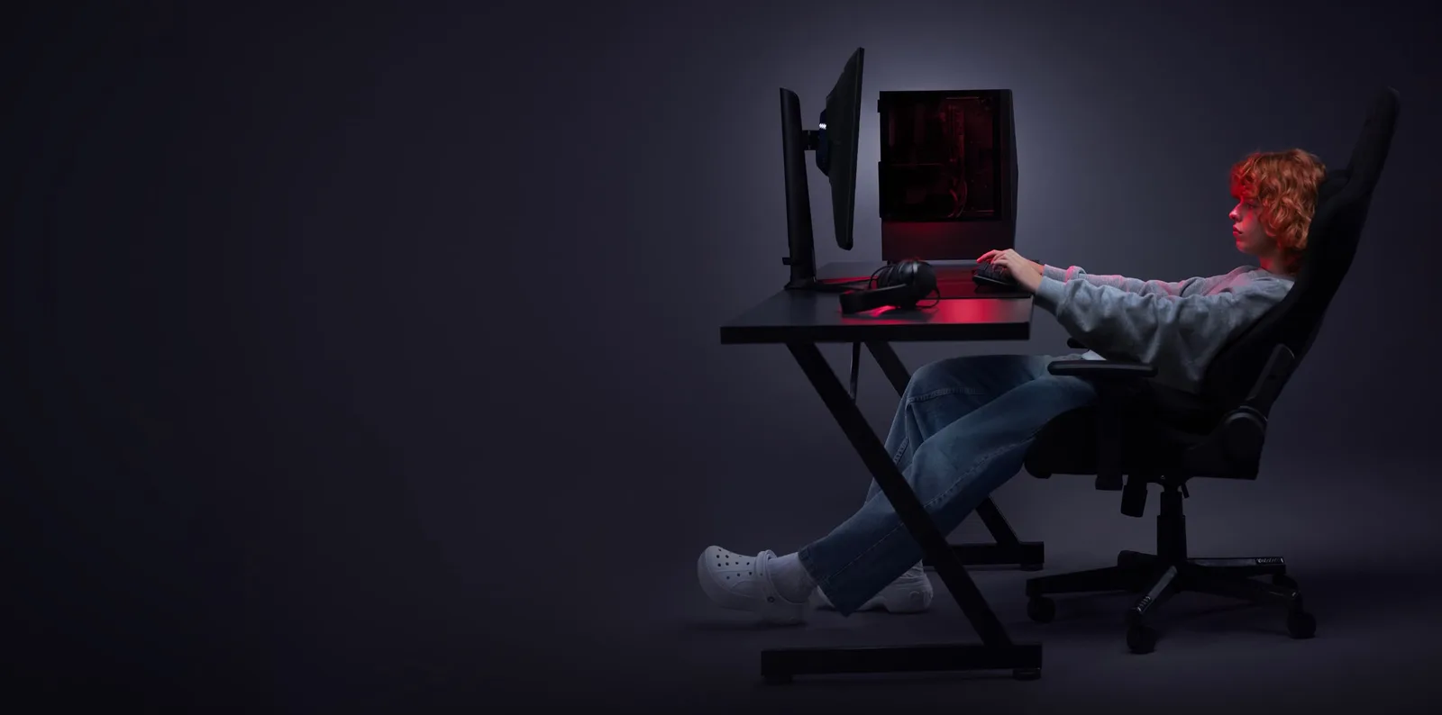 Official Opera image of a gamer at a desk with a monitor and a gaming PC