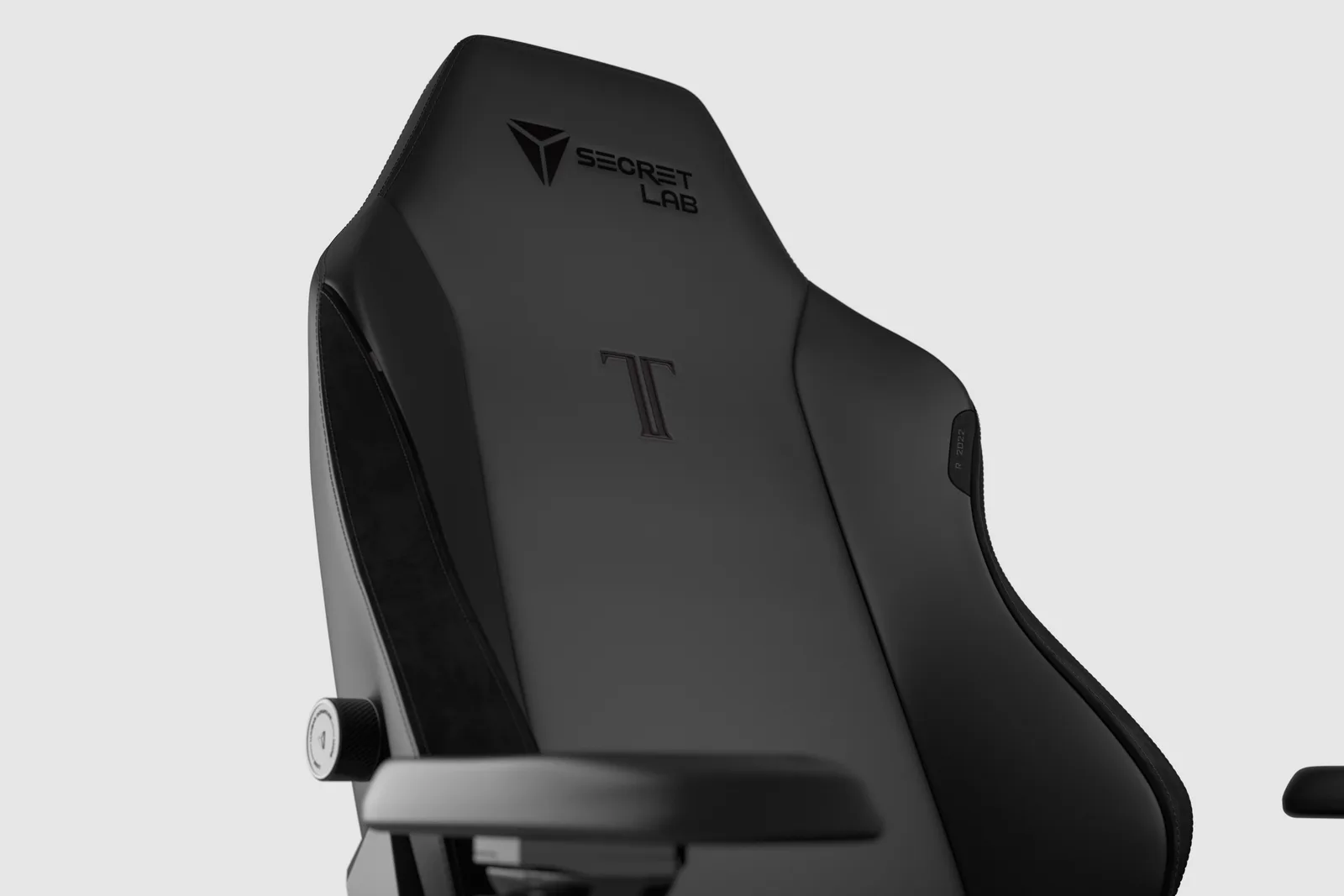 Close-up of the Secretlab TITAN Evo backrest showing the integrated lumbar support panel and adjustment dial