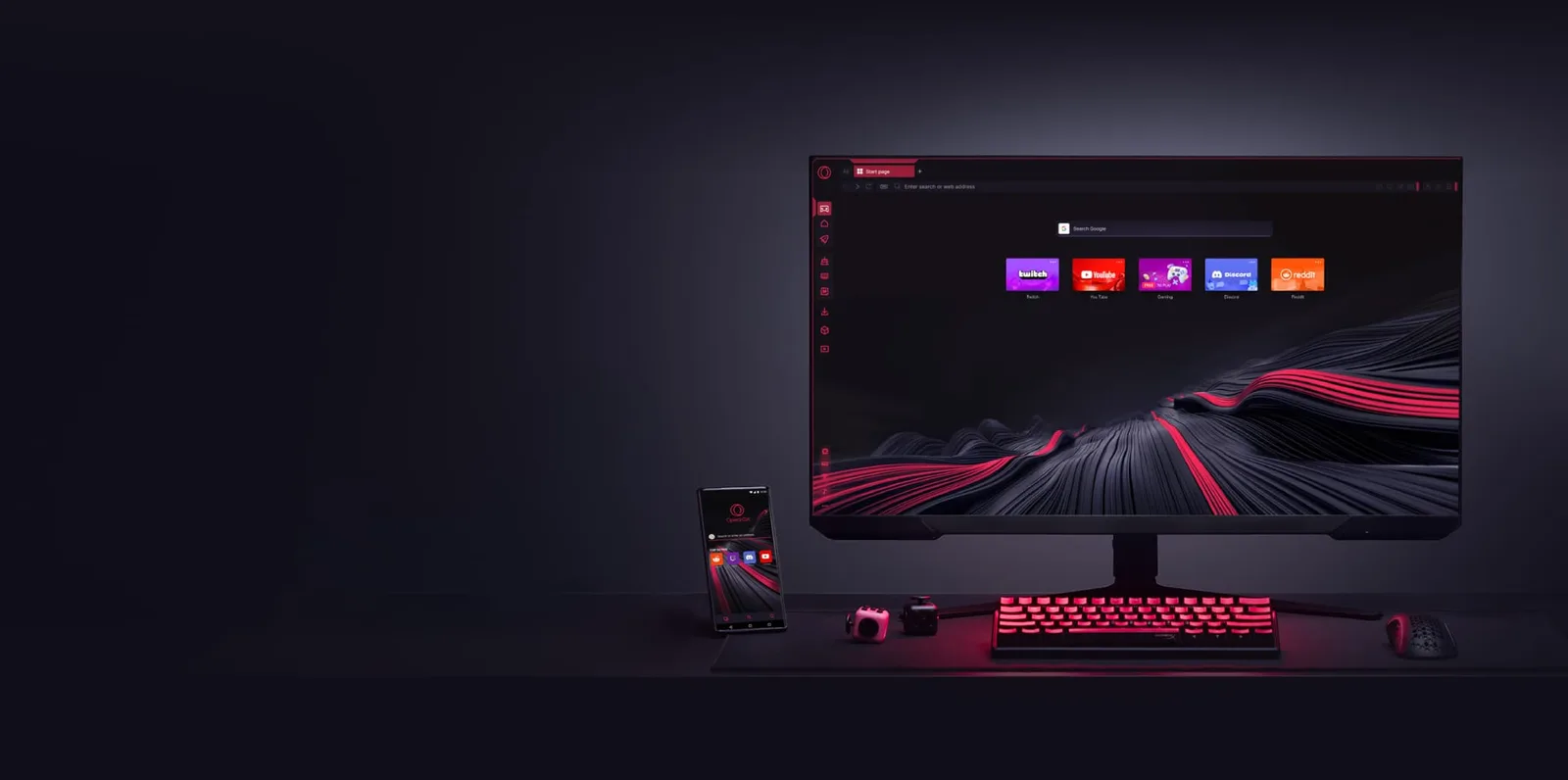 A dark desk with a monitor showing the Opera GX start page and its red wave wallpaper, next to a phone and a backlit keyboard